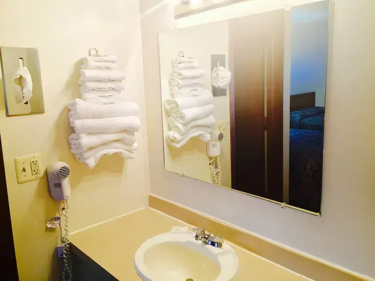 Sink with towels on the wall rack with tissue papers